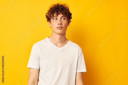 red-haired guy in a white t-shirt on a yellow background