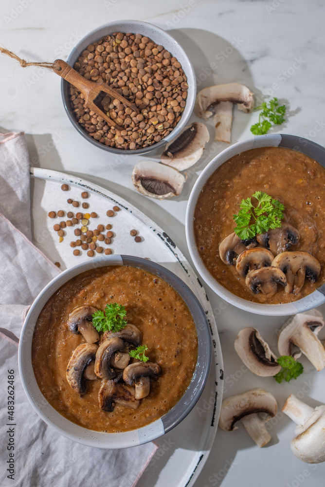 Mushroom soup of champignons and lentils in a bowl Mushroom soup of champignons and lentils in a bowl