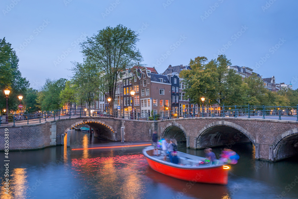 Spring Evening on the Amsterdam Canal and Pleasure Boat