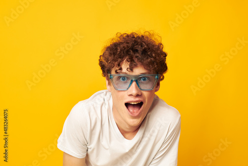 guy with red curly hair in blue glasses white t-shirt fashion modern style isolated background unaltered © Tatiana