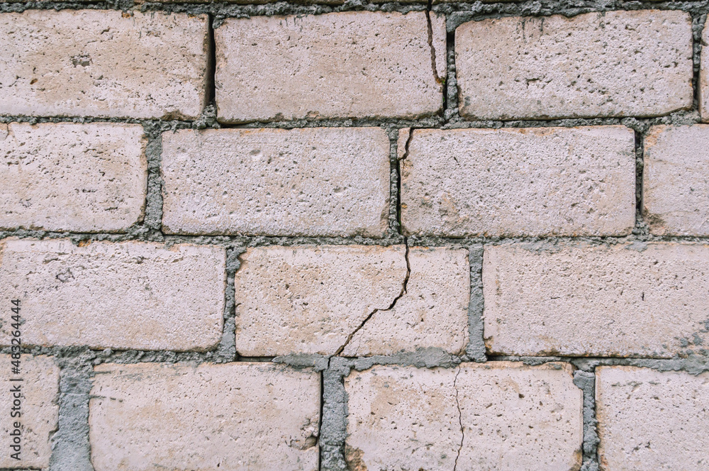 Poor-quality masonry walls using building blocks and cement mortar. The formation of cracks and crevices on the wall of building blocks. Marriage during construction. Poor-quality masonry walls using building blocks and cement mortar. The formation of cracks and crevices on the wall of building blocks. Marriage during construction.