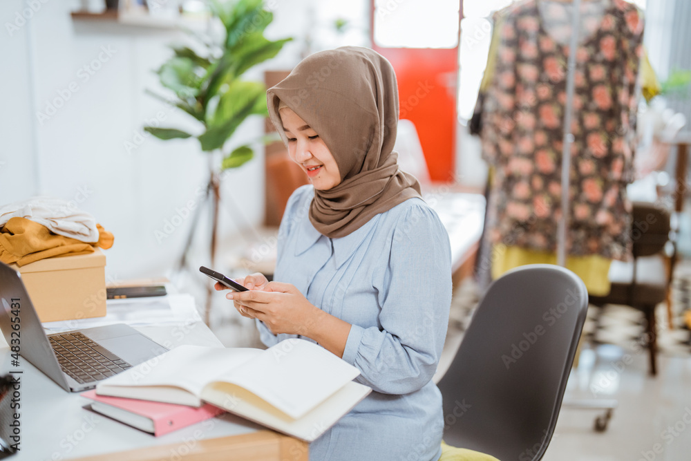 muslim businesswomen using mobile phone working muslim businesswomen using mobile phone working