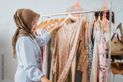 muslim fashion designer checking her dress product