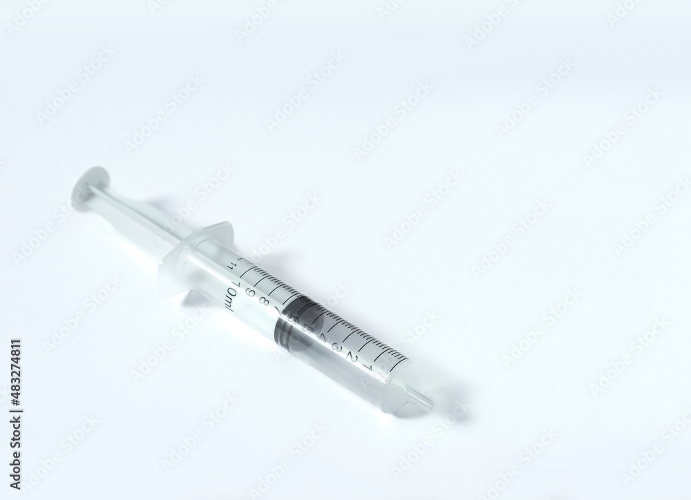 An image isolated selected focus empty syringe on the white background with copy space for text. An image isolated selected focus empty syringe on the white background with copy space for text.