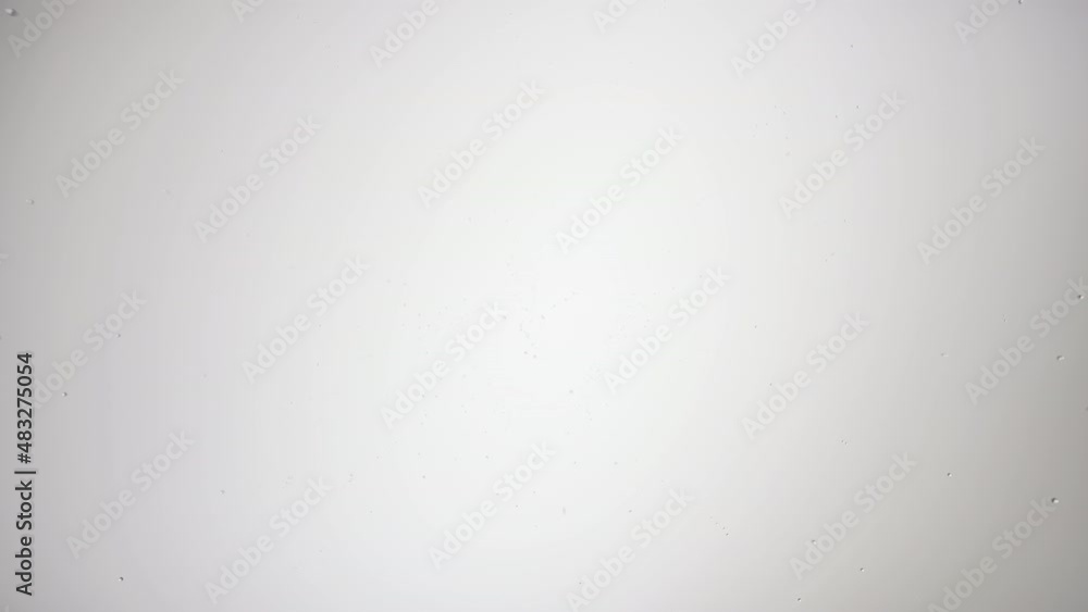 Checkmark printed on the wet glass blown off with air stream on grey background | antiperspirant advertisement Checkmark printed on the wet glass blown off with air stream on grey background | antiperspirant advertisement