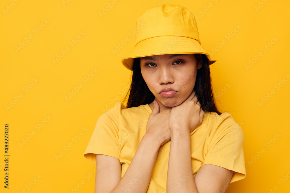 woman wearing a yellow hat posing emotions yellow background unaltered woman wearing a yellow hat posing emotions yellow background unaltered