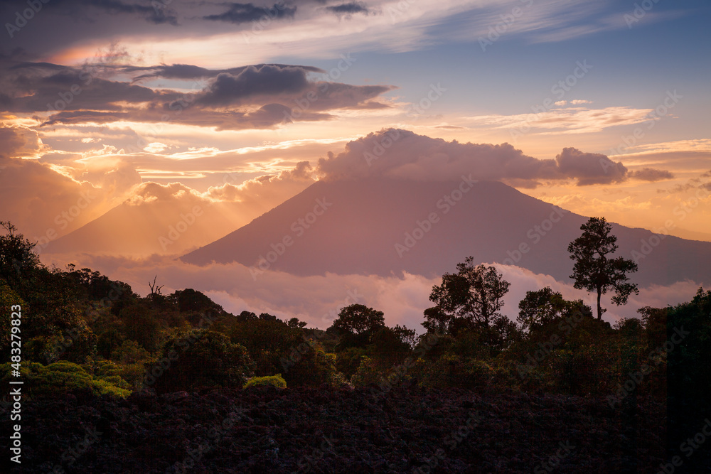Sea of clouds with sunset in volcanic mountain range of Antigua, Guatemala Sea of clouds with sunset in volcanic mountain range of Antigua, Guatemala