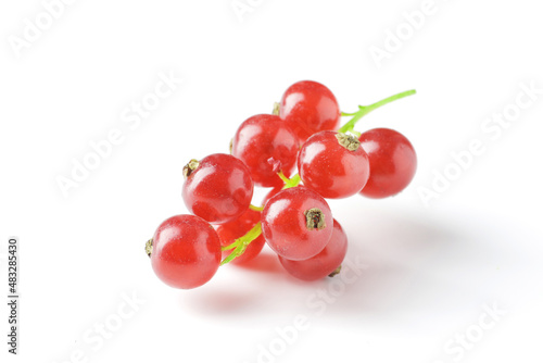 Berries of ripe tasty red currant isolated on white background. red currant with a leaf. a slide of red currants. Red currant berries with leaf isolated on white background.