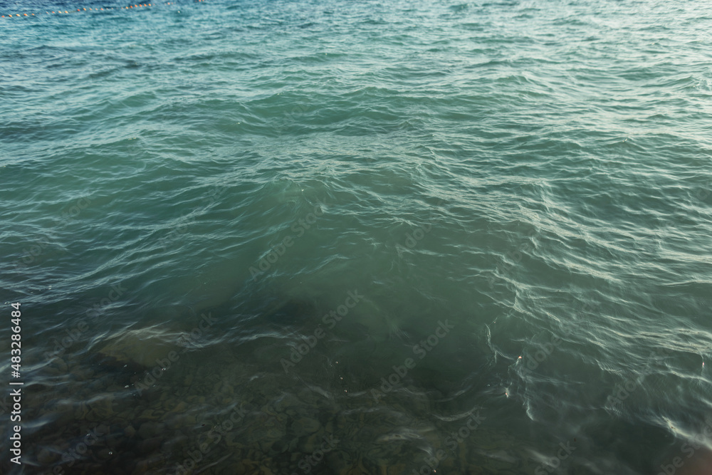 Beautiful green water with waves and ripples. Summer vacation by the sea. Sea and watercolor background