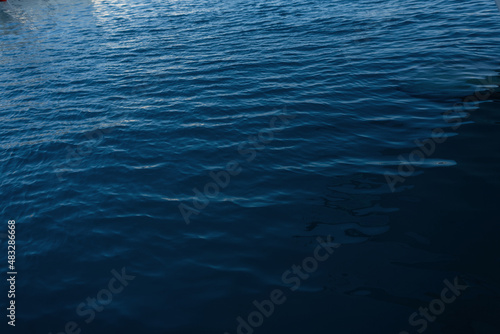 Blue water background. Sea with waves and ripples