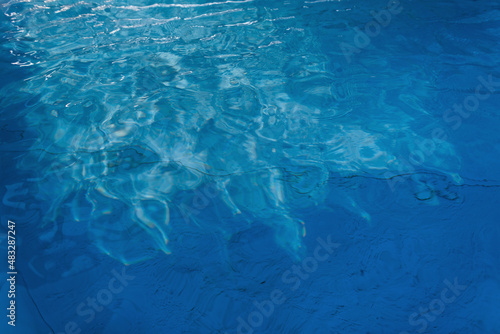 Beautiful blue water texture with waves and ripples. Clear water in the swimming pool