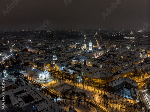 Aerial shot of Old City Lviv cowered by snow with churches and cathedrals.