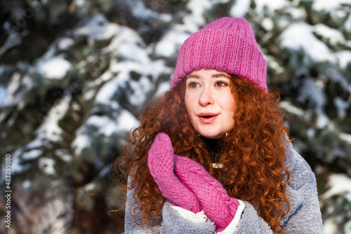 Portrait of a young beautiful woman in a winter park