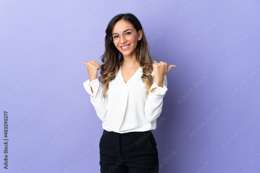 Young caucasian woman isolated on purple background with thumbs up gesture and smiling Young caucasian woman isolated on purple background with thumbs up gesture and smiling