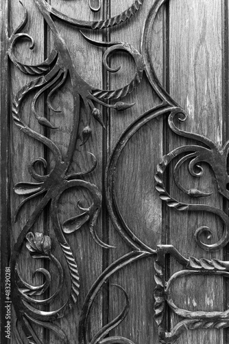 Decorative wrought iron fence elements on wooden doors