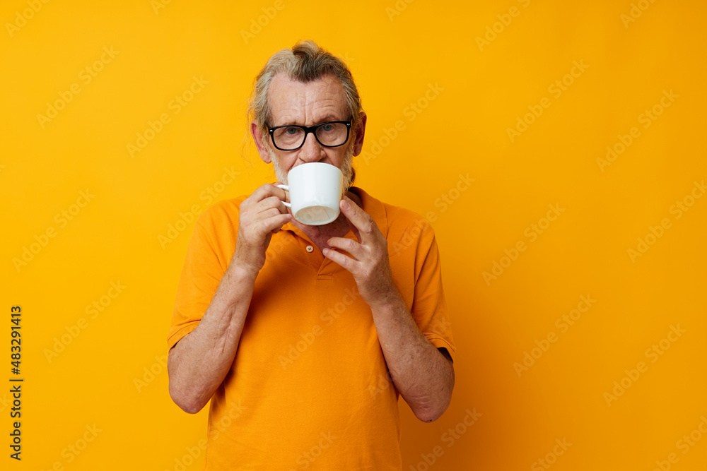 Photo of retired old man in a yellow t-shirt white mug monochrome shot Photo of retired old man in a yellow t-shirt white mug monochrome shot