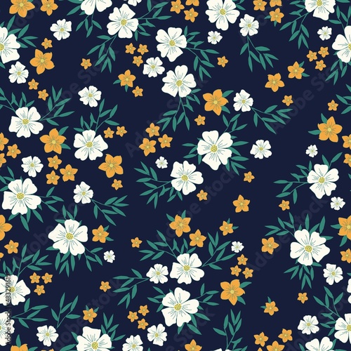 Beautiful vintage pattern. White and orange flowers  green leaves . Dark blue background. Floral seamless background. An elegant template for fashionable prints.