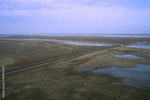 asphalt road and bridge over a lake in the steppe photo from a quadcopter landscape