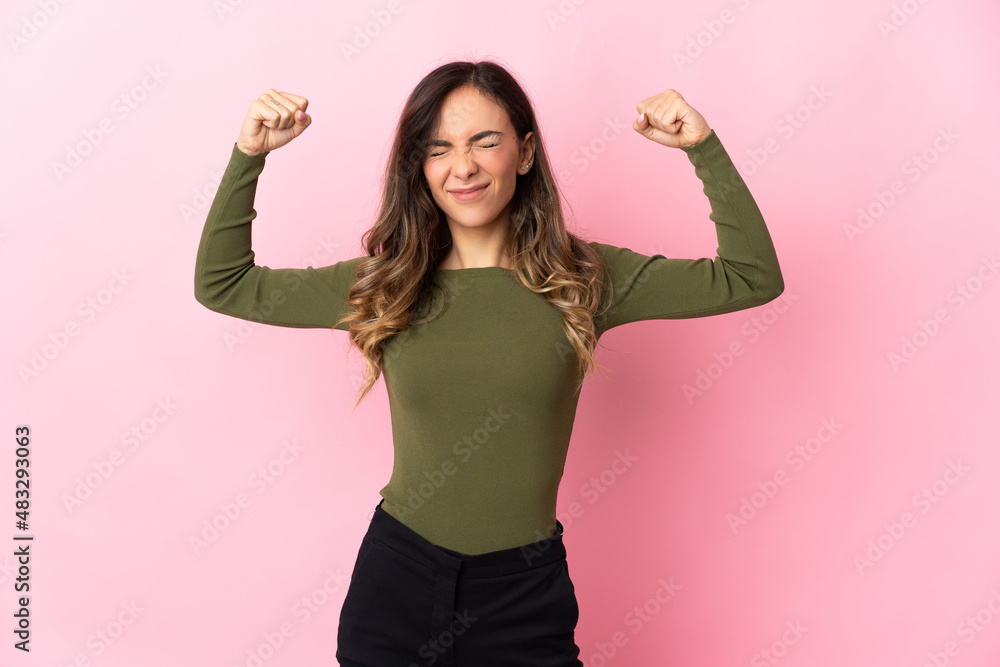 Young caucasian woman isolated on pink background doing strong gesture Young caucasian woman isolated on pink background doing strong gesture