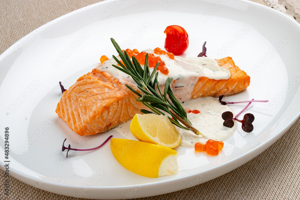 Salmon fillet with sauce and red caviar, rosemary and lemon. Salmon fillet with sauce and red caviar, rosemary and lemon.