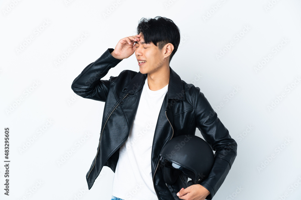 Chinese man with a motorcycle helmet isolated on white background smiling a lot Chinese man with a motorcycle helmet isolated on white background smiling a lot