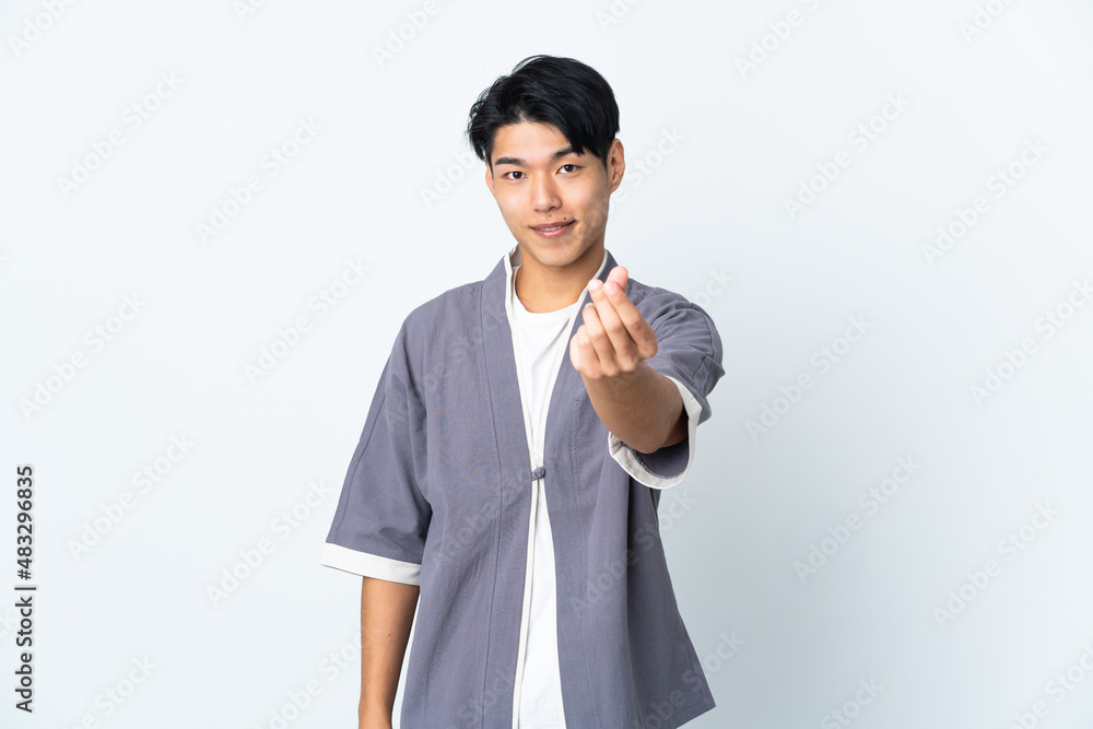 Young Chinese man isolated on white background making money gesture Young Chinese man isolated on white background making money gesture
