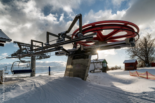 Upper station of ski-lift chair at resort Snowland Valca in winter season. photo