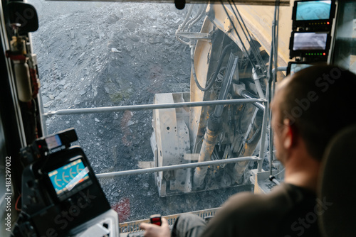 View from the cab of a heavy excavator at a gold mining site.	