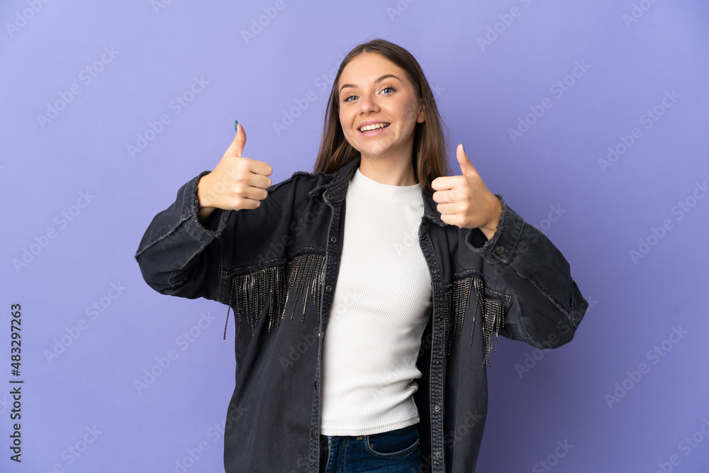 Young Lithuanian woman isolated on purple background giving a thumbs up gesture Young Lithuanian woman isolated on purple background giving a thumbs up gesture