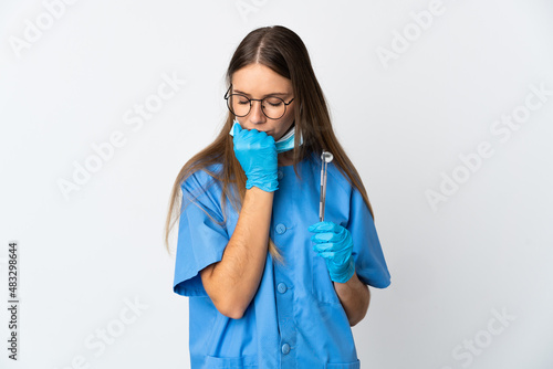 Lithuanian woman dentist holding tools over isolated background having doubts
