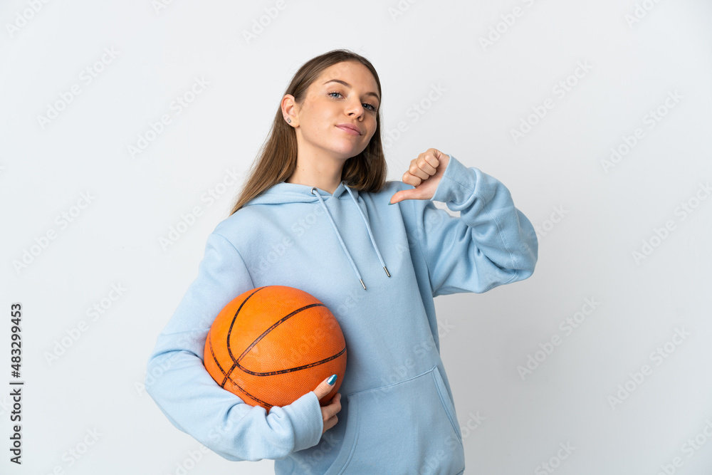 Young Lithuanian woman playing basketball isolated on white background proud and self-satisfied