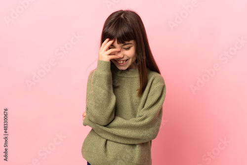 Little girl isolated on pink background laughing © luismolinero
