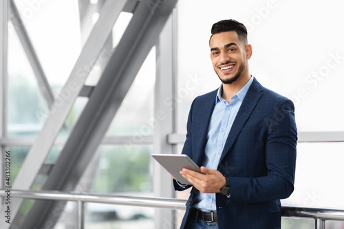 Modern Entrepreneurship. Handsome Arab Businessman With Digital Tablet Posing At Airport Terminal
