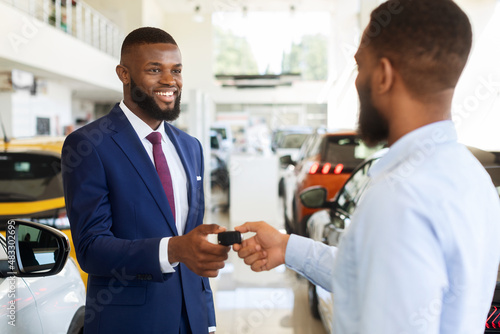 Car Sales Or Rent. Black Manager Giving Keys To Male Customer, Closeup