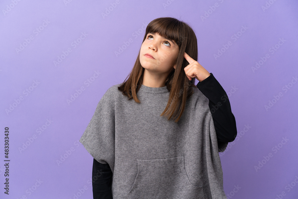Little girl over isolated background making the gesture of madness putting finger on the head Little girl over isolated background making the gesture of madness putting finger on the head