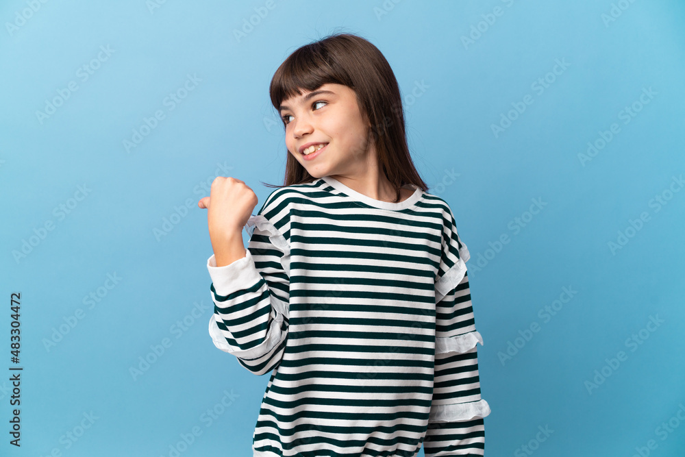 Little girl over isolated background pointing to the side to present a product Little girl over isolated background pointing to the side to present a product