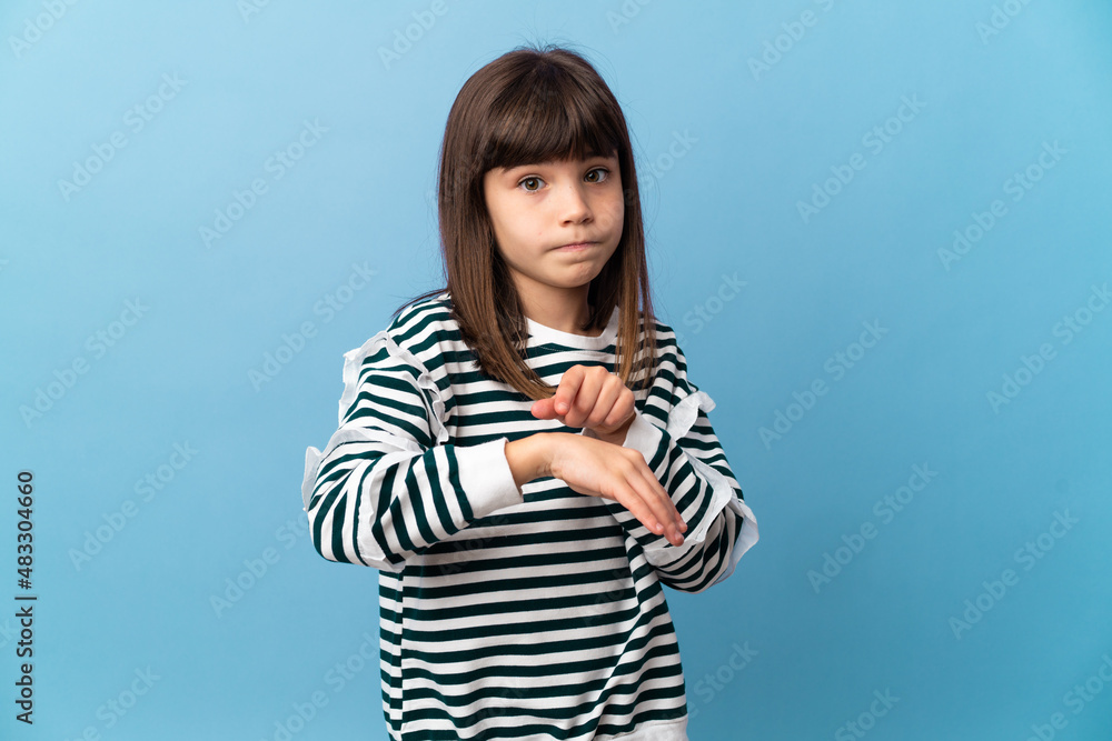 Little girl over isolated background making the gesture of being late Little girl over isolated background making the gesture of being late