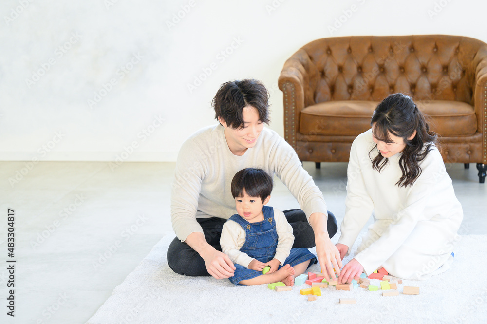 Young family playing with baby in family room with beautiful mom in clean new like room, overhead view, wide angle Young family playing with baby in family room with beautiful mom in clean new like room, overhead view, wide angle