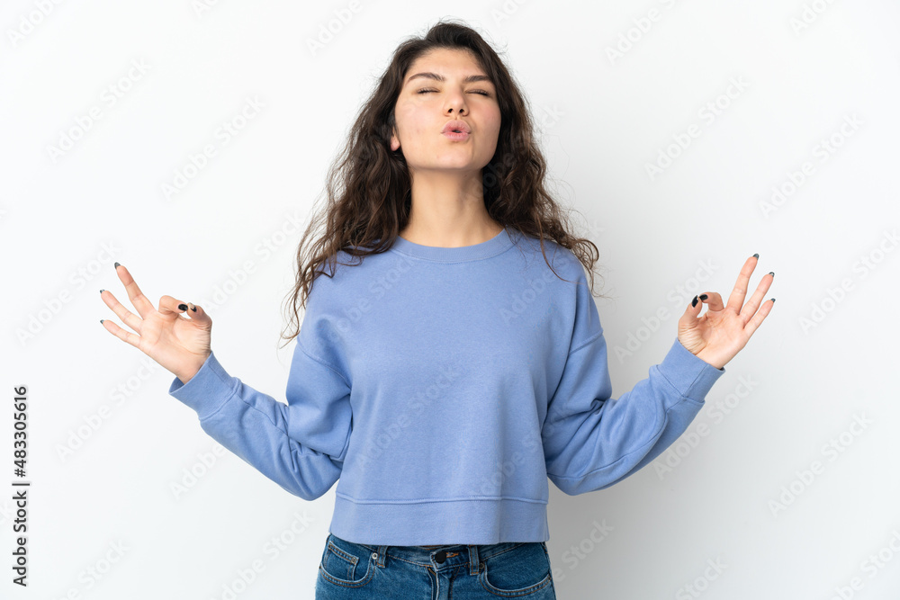 Teenager Russian girl isolated on white background in zen pose Teenager Russian girl isolated on white background in zen pose