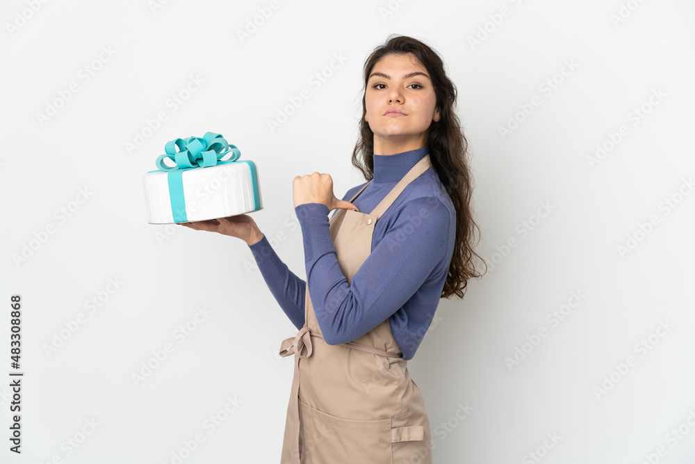 Pastry Russian chef holding a big cake isolated on white background proud and self-satisfied Pastry Russian chef holding a big cake isolated on white background proud and self-satisfied