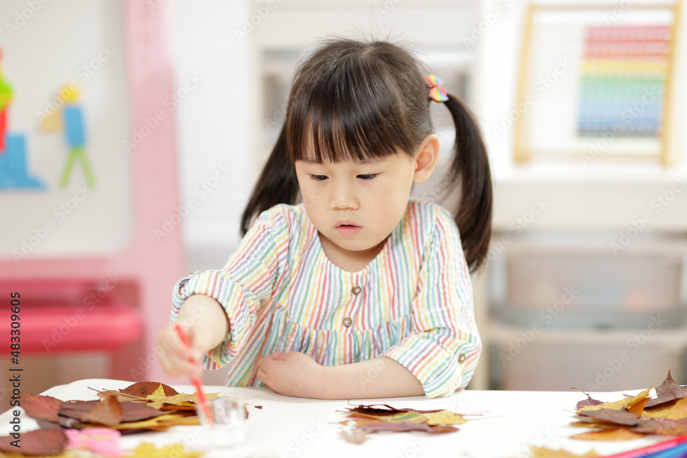 young girl making craft for home schooling young girl making craft for home schooling