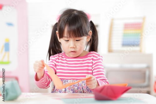 young girl making craft for home schooling