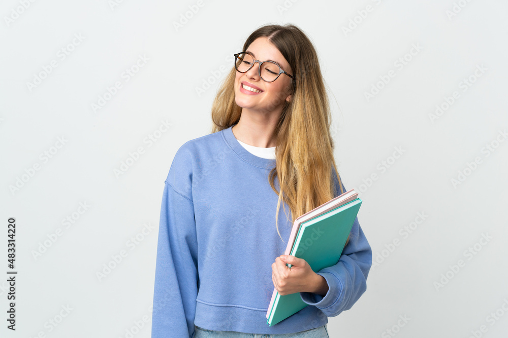Young blonde student woman isolated on white background looking to the side and smiling Young blonde student woman isolated on white background looking to the side and smiling