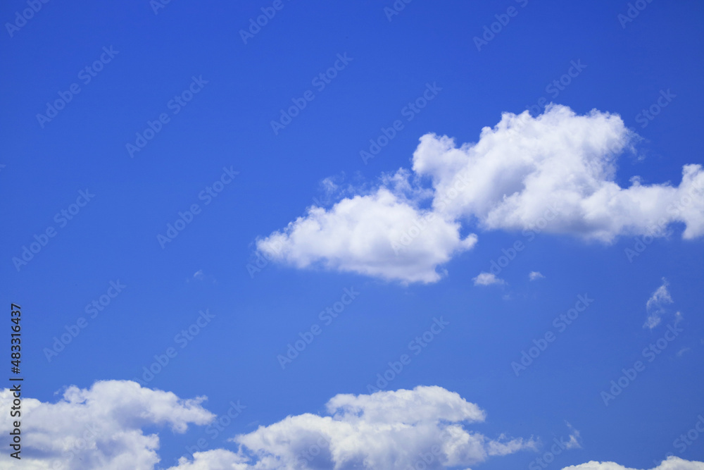A scenery of clear blue sky with soft and fluffy white cloud in spring time with copy space for background 