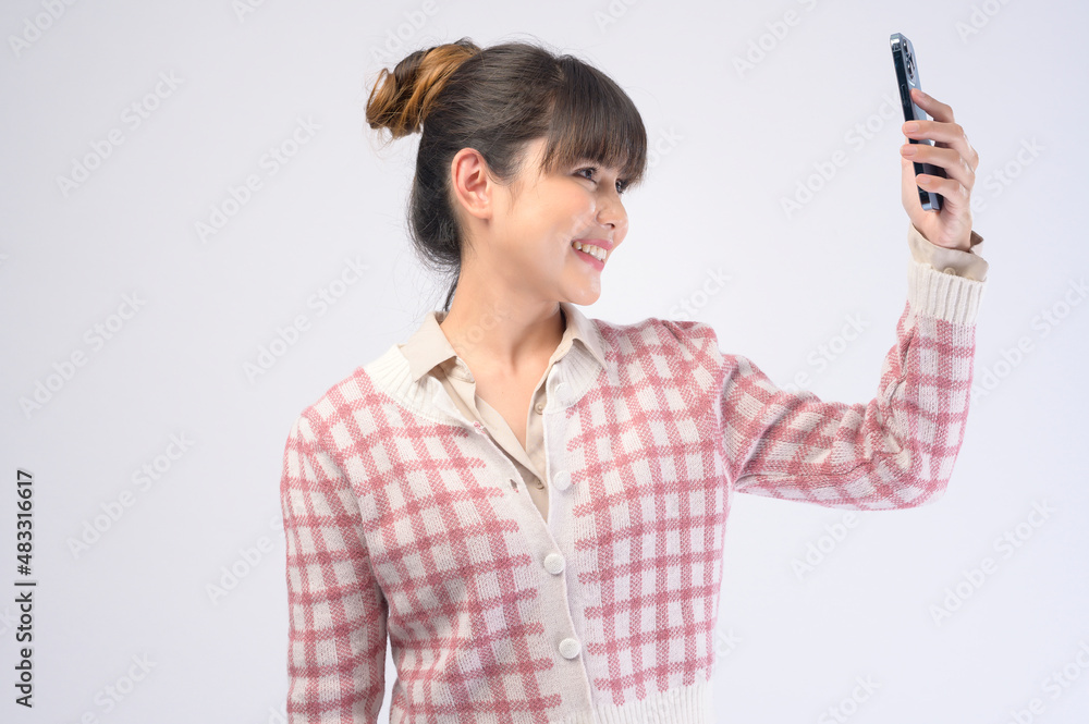 Young beautiful woman using smart phone isolated on white background Young beautiful woman using smart phone isolated on white background