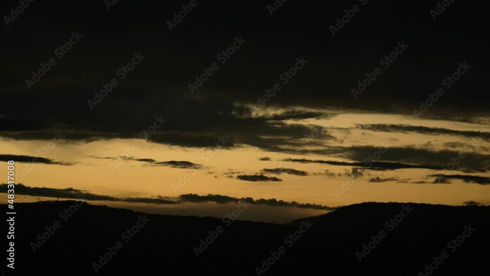 Beautiful Sunset and Silhouette of the hills with clouds rolling by. Beautiful Sunset and Silhouette of the hills with clouds rolling by.