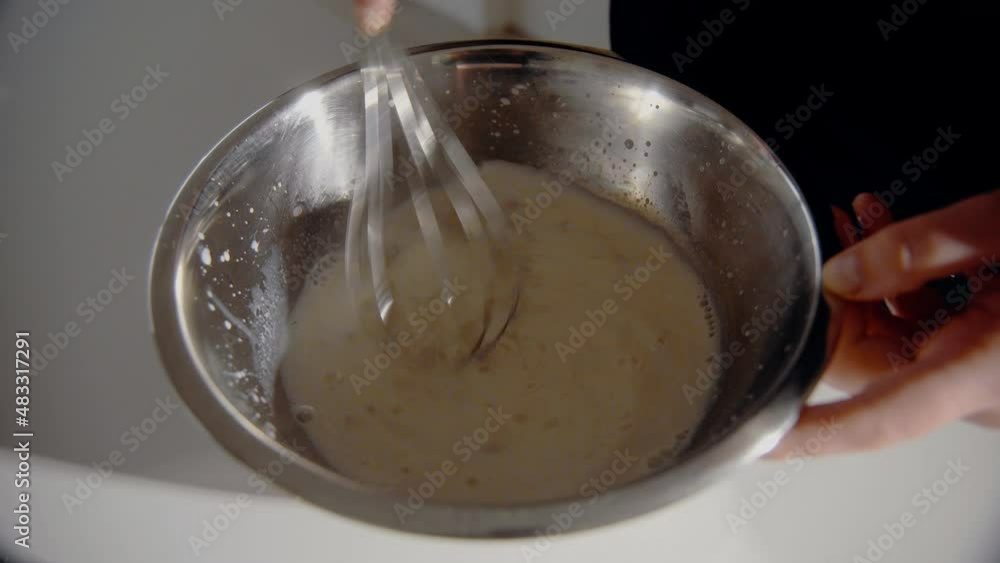 Young Female mixing yeast and milk for a cake in the kitchen at home. Homemade pastry close up Young Female mixing yeast and milk for a cake in the kitchen at home. Homemade pastry close up