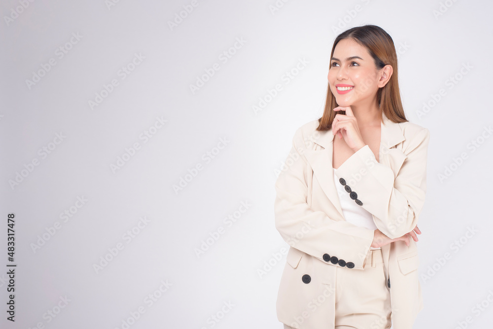 Portrait of young beautiful businesswoman wearing suit in white background studio.. Portrait of young beautiful businesswoman wearing suit in white background studio..
