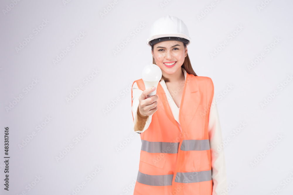 a woman engineer wearing a protective helmet over white background studio a woman engineer wearing a protective helmet over white background studio