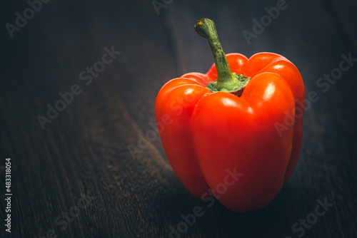 Fotografia A red bell pepper or paprika on wooden floor, Vegetable or food background, Nobo